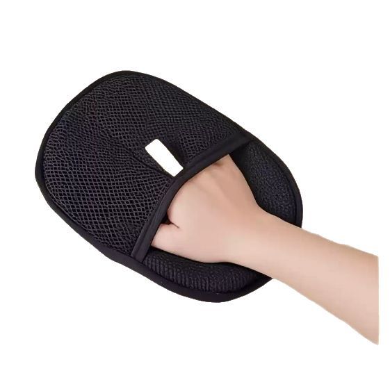 Person using deshedding glove to groom cat